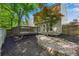 Backyard featuring a wooden deck, sliding glass doors, mulch beds, and scattered trees, offering a private retreat at 562 Poplar Bnd, Canton, GA 30114