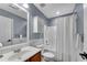 Well-lit bathroom featuring a shower-tub combination and a vanity with ample storage and mirror at 562 Poplar Bnd, Canton, GA 30114