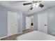 Bedroom showcasing neutral walls, doors and a ceiling fan; with an open door leading to another room at 562 Poplar Bnd, Canton, GA 30114