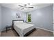 Cozy bedroom with a ceiling fan, gray walls, and natural light from the window creates a calming atmosphere at 562 Poplar Bnd, Canton, GA 30114