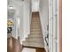 Welcoming foyer with hardwood floors and a carpeted staircase leading upstairs at 562 Poplar Bnd, Canton, GA 30114