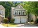 Traditional two-story home featuring an attached garage and lush landscaping at 562 Poplar Bnd, Canton, GA 30114