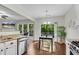 Sunlit eat-in kitchen with stainless steel appliances, counter seating, and backyard access at 562 Poplar Bnd, Canton, GA 30114