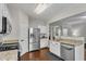 Modern kitchen with stainless appliances, stone counters, and hardwood floors at 562 Poplar Bnd, Canton, GA 30114
