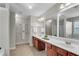 Bright main bathroom with double vanity, framed mirrors, updated fixtures, and natural light at 562 Poplar Bnd, Canton, GA 30114