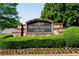 Elegant community sign for 'Prominence Court', surrounded by manicured landscaping, showcasing curb appeal at 562 Poplar Bnd, Canton, GA 30114