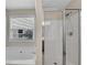 Relaxing bathroom featuring a shower and a tub next to a bright window at 562 Poplar Bnd, Canton, GA 30114