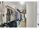 Organized walk-in closet with ample hanging space, shelves and carpeted floor at 562 Poplar Bnd, Canton, GA 30114
