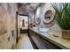 Bathroom with a long vanity, vessel sinks, wood-framed mirrors, and mosaic-tiled walls and access to bedroom at 1250 Parkwood Se Cir # 3001, Atlanta, GA 30339