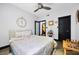 Well-lit bedroom features a queen bed, neutral walls, and an ornate clock hanging on the wall at 1250 Parkwood Se Cir # 3001, Atlanta, GA 30339