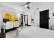 Bright bedroom with light walls, a queen bed, an office chair, and ceiling fan at 1250 Parkwood Se Cir # 3001, Atlanta, GA 30339