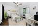 Bright bedroom with light walls, a queen bed, office chair, and lots of natural light at 1250 Parkwood Se Cir # 3001, Atlanta, GA 30339