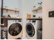Laundry room with washer, dryer, wooden shelves and decor at 2543 Oakbourne Ln # 14, Smyrna, GA 30080