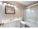 Bathroom with a tub and sliding shower doors, a white toilet, and a wood-trimmed mirror at 465 Willowbrook Se Dr, Smyrna, GA 30082