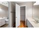 Bright bathroom featuring a walk-in closet, wooden floors, and a vanity with white cabinets at 465 Willowbrook Se Dr, Smyrna, GA 30082