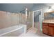 Bathroom featuring a corner shower, soaking tub, and tiled walls with updated fixtures at 465 Willowbrook Se Dr, Smyrna, GA 30082
