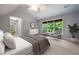 Cozy bedroom with serene ambiance and windows offering views of the verdant outdoors at 465 Willowbrook Se Dr, Smyrna, GA 30082