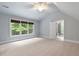 Spacious bedroom with large windows, natural light, ceiling fan, and light gray walls at 465 Willowbrook Se Dr, Smyrna, GA 30082