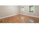 Bright bedroom featuring hardwood floors, a large window, and fresh paint at 465 Willowbrook Se Dr, Smyrna, GA 30082
