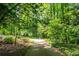 View of a driveway surrounded by trees at 465 Willowbrook Se Dr, Smyrna, GA 30082