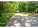 View of long driveway shaded by lush green trees at 465 Willowbrook Se Dr, Smyrna, GA 30082