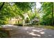 Front exterior featuring an attached garage and lush landscaping at 465 Willowbrook Se Dr, Smyrna, GA 30082