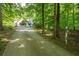 View of the home exterior and driveway featuring mature trees at 465 Willowbrook Se Dr, Smyrna, GA 30082