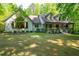 Charming home featuring manicured lawn, mature trees and welcoming front porch at 465 Willowbrook Se Dr, Smyrna, GA 30082