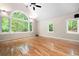 Bright living room boasts hardwood floors, a ceiling fan, and scenic backyard views at 465 Willowbrook Se Dr, Smyrna, GA 30082