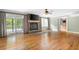 Spacious living room with hardwood floors, stone fireplace, and access to an outdoor deck at 465 Willowbrook Se Dr, Smyrna, GA 30082