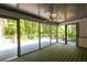 Enclosed porch featuring wood ceiling and floor and views of a lush, wooded landscape at 465 Willowbrook Se Dr, Smyrna, GA 30082