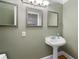Quaint powder room with pedestal sink and stylish mirrors at 465 Willowbrook Se Dr, Smyrna, GA 30082