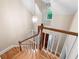 Bright staircase with wood steps, white railings, and a hanging pendant light at 465 Willowbrook Se Dr, Smyrna, GA 30082