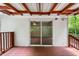 Back porch with sliding glass doors and wooded view at 6670 George Ct, Cumming, GA 30041