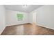 Bedroom featuring neutral paint, wood flooring, and a window for natural light at 6670 George Ct, Cumming, GA 30041