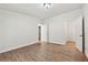 A spacious bedroom featuring wood flooring and two doorways, offering versatile access at 6670 George Ct, Cumming, GA 30041