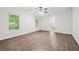 Bedroom featuring neutral paint, wood flooring, ceiling fan, and a window for natural light at 6670 George Ct, Cumming, GA 30041