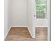 Walk-in closet featuring neutral paint, wood flooring, and a window for natural light at 6670 George Ct, Cumming, GA 30041