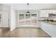 Eat-in kitchen area featuring large windows, wood floors and granite countertops at 6670 George Ct, Cumming, GA 30041