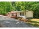 Well-maintained single-story home with a spacious wooden deck and beautifully landscaped yard at 6670 George Ct, Cumming, GA 30041