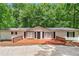 Charming one-story home with a large wooden deck, perfect for relaxing outdoors at 6670 George Ct, Cumming, GA 30041