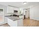 Modern kitchen equipped with granite countertops, white cabinets, and stainless steel appliances at 6670 George Ct, Cumming, GA 30041