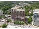 Aerial view of a brick apartment building complemented by green spaces and city views at 1820 Peachtree St # 614, Atlanta, GA 30309