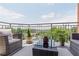 Outdoor balcony space features comfortable seating, a table, neutral rug, and offers great views of the surrounding neighborhood at 1820 Peachtree St # 614, Atlanta, GA 30309