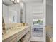 Bright bathroom features marble countertops with double sinks and a glimpse of the bedroom through the doorway at 1820 Peachtree St # 614, Atlanta, GA 30309