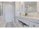 Bright bathroom featuring marble counters, updated fixtures, a glass shower and white tiling at 1820 Peachtree St # 614, Atlanta, GA 30309