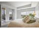 Bright bedroom features large windows with neighborhood views and sliding glass doors to a private balcony at 1820 Peachtree St # 614, Atlanta, GA 30309