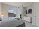 Bedroom boasts natural light with a large window, television, and soft gray carpeting at 1820 Peachtree St # 614, Atlanta, GA 30309