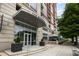Inviting building entrance with planters, a covered awning, and glass doors at 1820 Peachtree St # 614, Atlanta, GA 30309