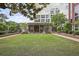 Expansive green lawn in front of building exterior with landscaped garden and brick pathways at 1820 Peachtree St # 614, Atlanta, GA 30309